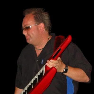 John Seppala playing a red keytar